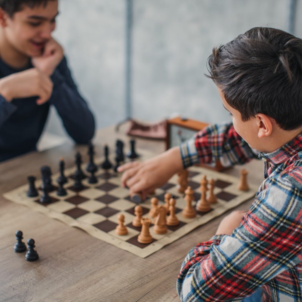 two kids playing chess Types Chess Games